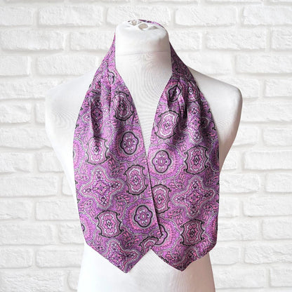 Purple paisley scarf on a mannequin against a white brick wall background