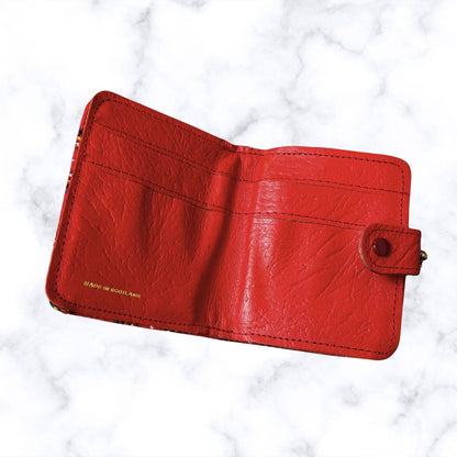 Red wallet on a white marble background