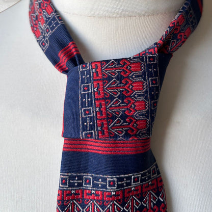 Traditional patterned tie  on a mannequin with a plain background