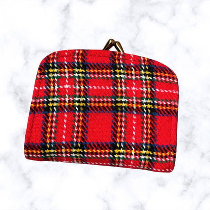 Red plaid pouch on a white marble background
