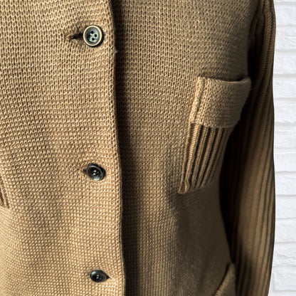 Close-up of a brown knitted cardigan with buttons on a white background