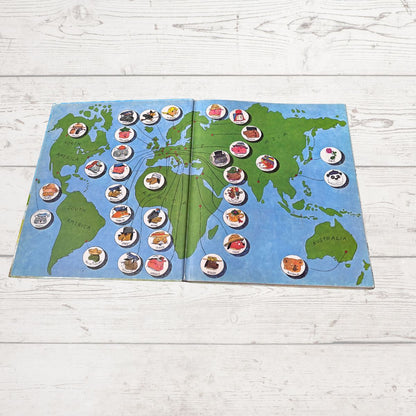 World map in book with various characters  on a wooden surface