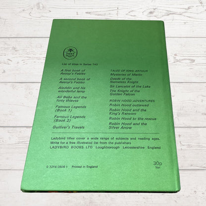 The back cover of a green Ladybird Books children's book, titled 'A List of Titles in Series 740', photographed flat on a white wood background.