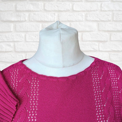 Pink sweater on a mannequin against a white brick wall background