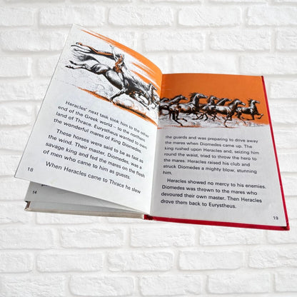 Open vintage book featuring horses 