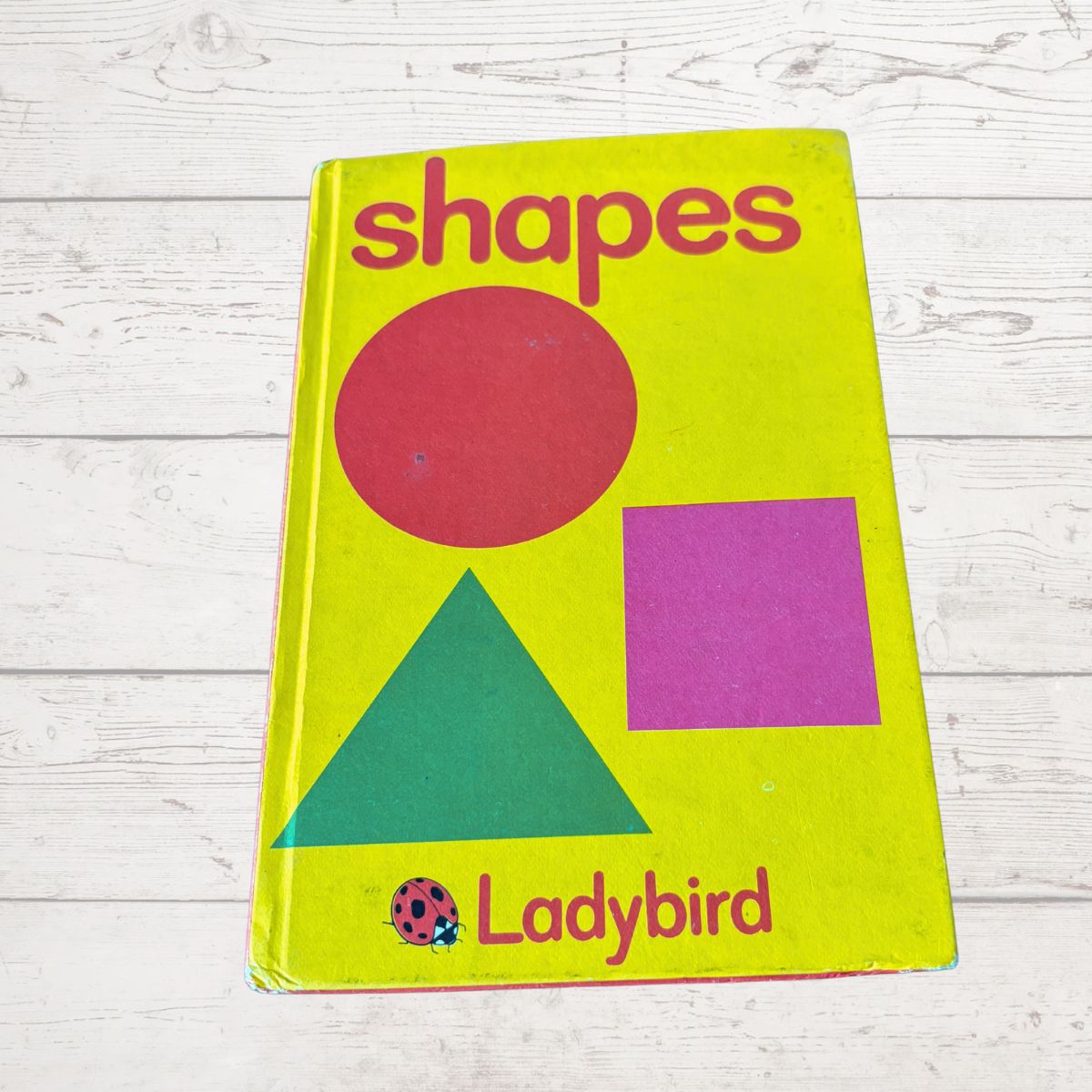 Vintage 'shapes' Ladybird book on a wooden surface