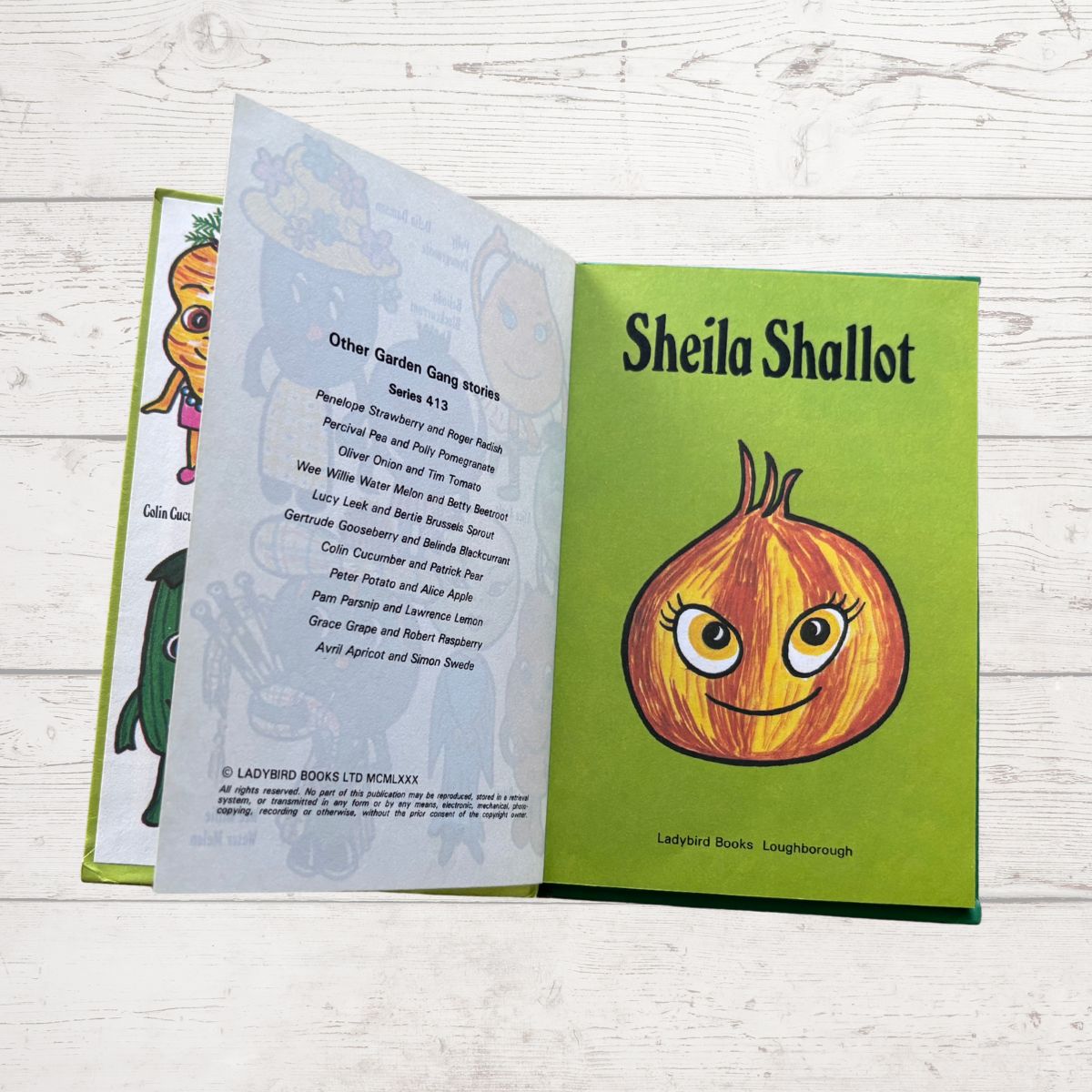 Open book showing a character named Sheila Shallot on a green background