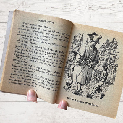 Open book with illustrations and text on a wooden surface