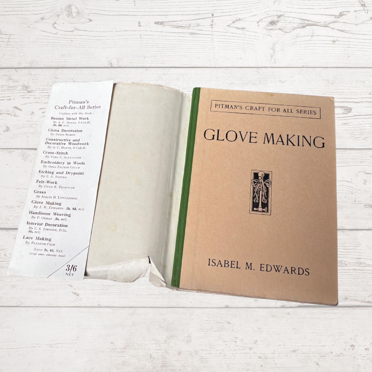 Open book titled 'Glove Making' by Isabel M. Edwards on a wooden surface
