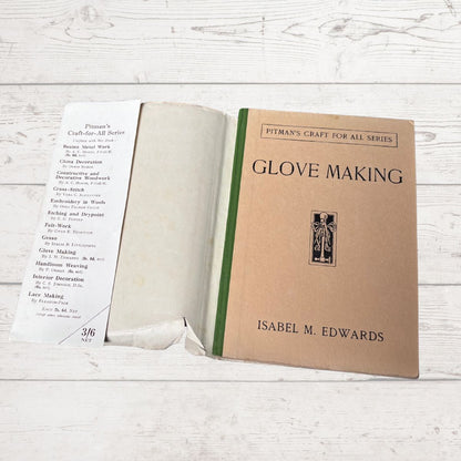 Open book titled 'Glove Making' by Isabel M. Edwards on a wooden surface