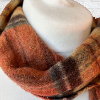 Plaid scarf with orange and brown pattern on a white background