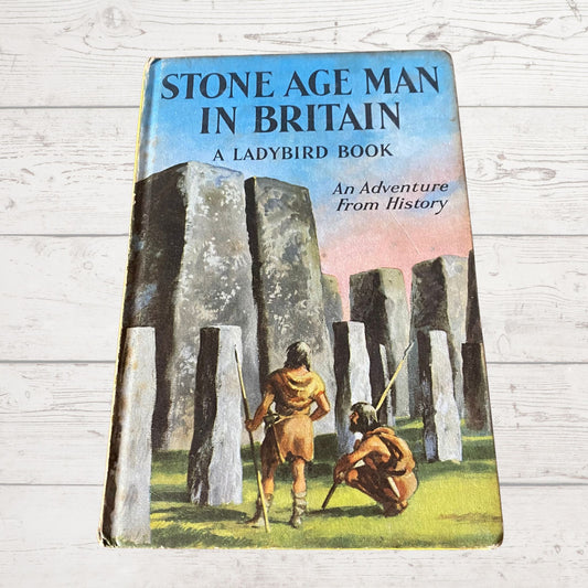 A vintage 1960s Ladybird book titled 'Stone Age Man in Britain', featuring illustrations of prehistoric characters and stone structures on the cover.