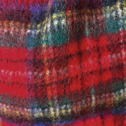 Close-up of a textured plaid fabric with red and multicolour pattern