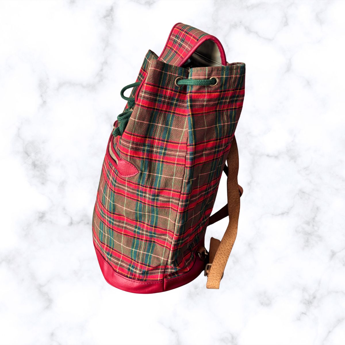 Plaid backpack on a white marble background