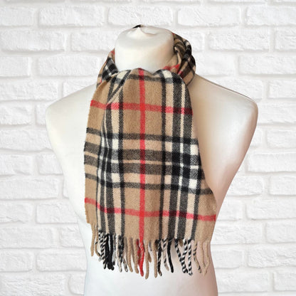 Plaid scarf on a mannequin against a white brick wall background