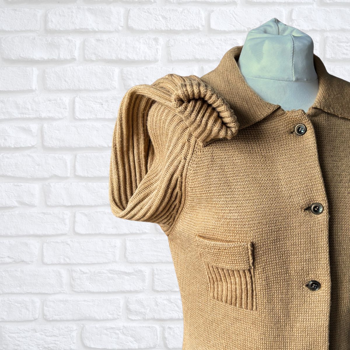 Textured knit cardigan with ribbed sleeves on a white background 