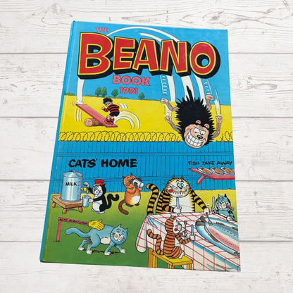 Cover of The Beano Book 1983 on a wooden surface