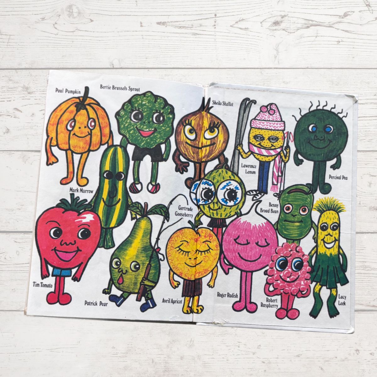 Colorful character illustrations on a paper with a wooden surface background