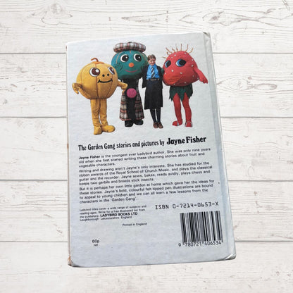 Back cover of a book featuring colorful characters on a wooden surface