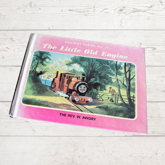 Book titled 'The Little Old Engine' by W. Awdry on a wooden surface