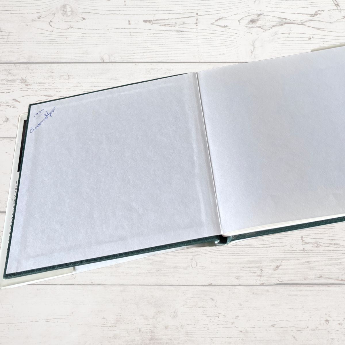 Open book on a light wooden surface