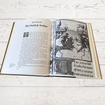 Open book with text and illustration on a wooden surface