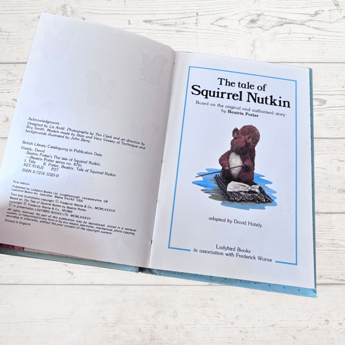 Open book with a cover featuring a squirrel and text about 'The Tale of Squirrel Nutkin'.