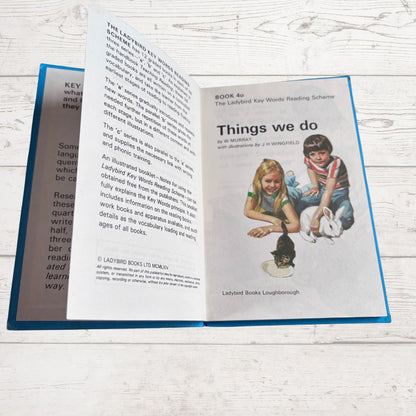Open book showing a page with text and an illustration of two children with a rabbit.