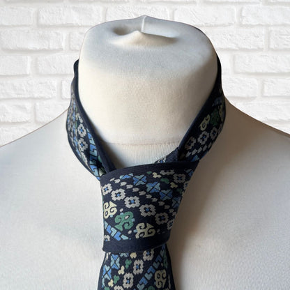 Close up of Blue, green, grey and cream patterned tie 