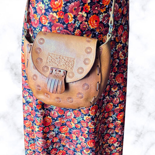 Small tooled leather bag on a floral dress 