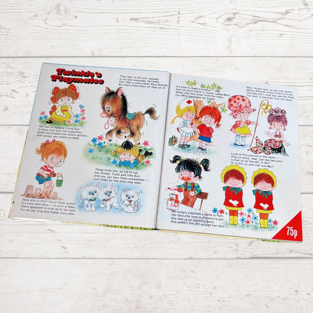 An open vintage children's book  laid flat on a white wood surface. The pages feature colorful cartoon illustrations of children, a horse, flowers, and text, with a red '75p' corner stamp on the right 