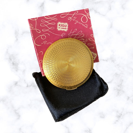 60s gold tone boxed and unused KIGU powder compact