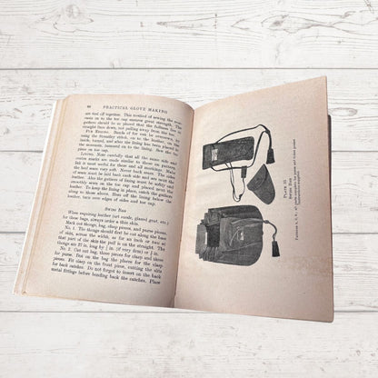 Open book with text and illustrations on a wooden surface