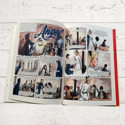 Comic book open to a page titled 'Angel' on a wooden surface