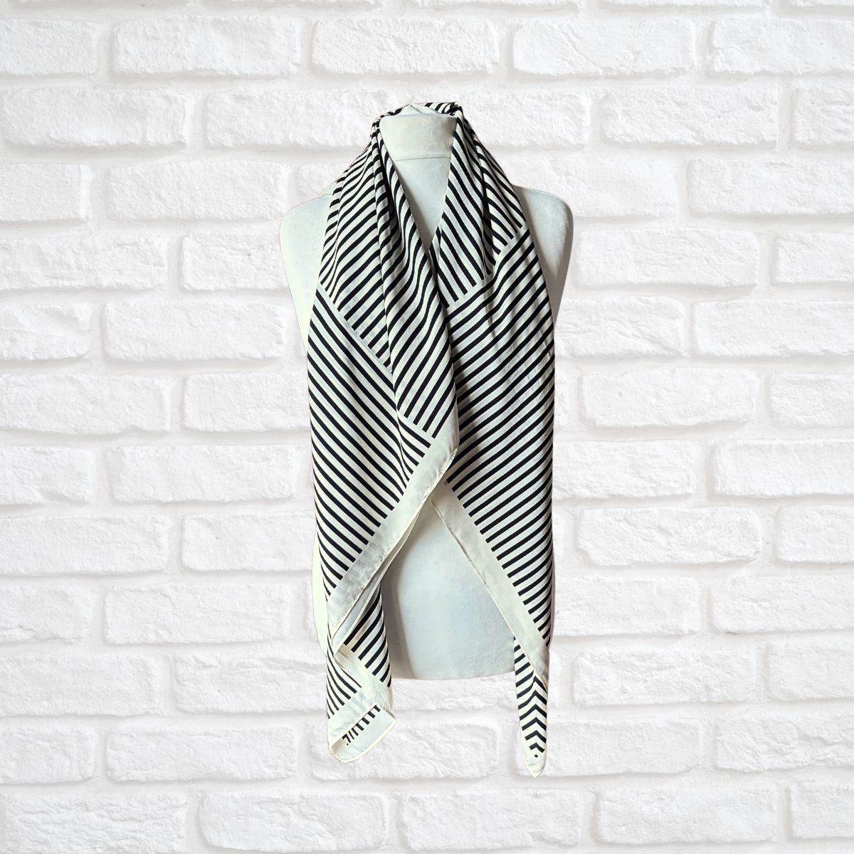 Cream and black striped vintage scarf on a white background 