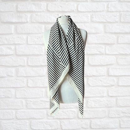Cream and black striped vintage scarf on a white background 