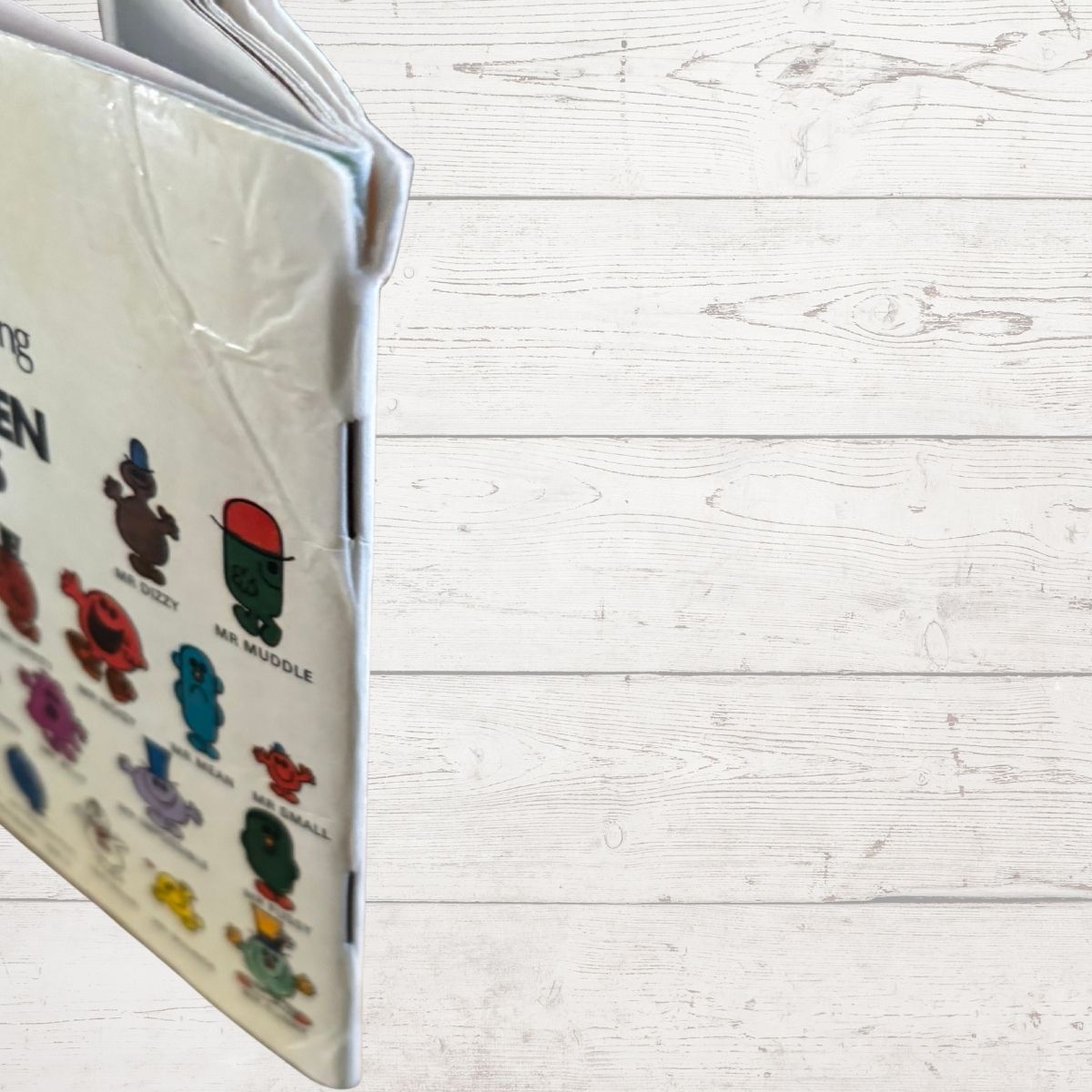 Book with colorful illustrations on a white wooden surface