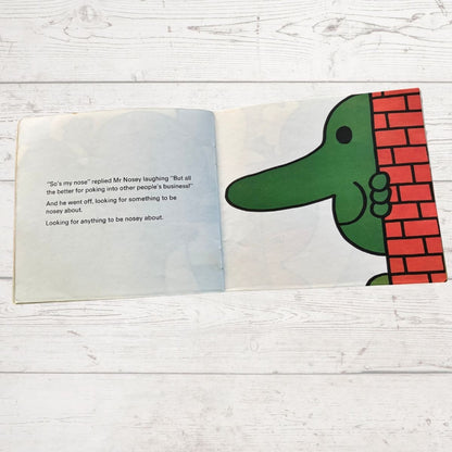 Mr Nosey peaking out from behind a wall 