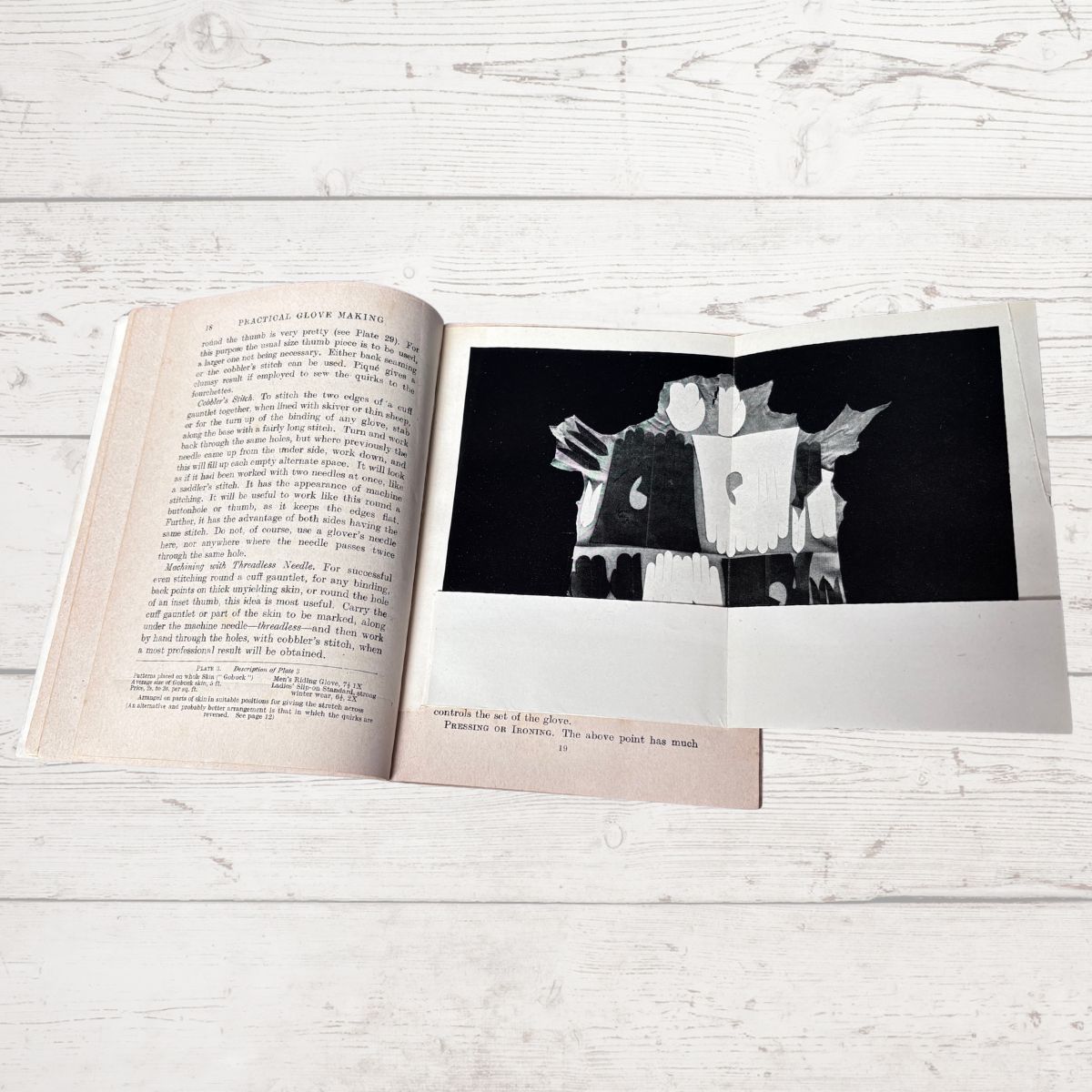 Open book with a black and white photograph on a wooden surface