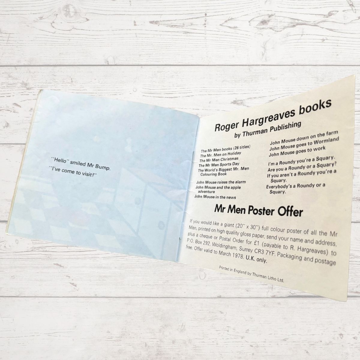 Open book with text on a wooden surface