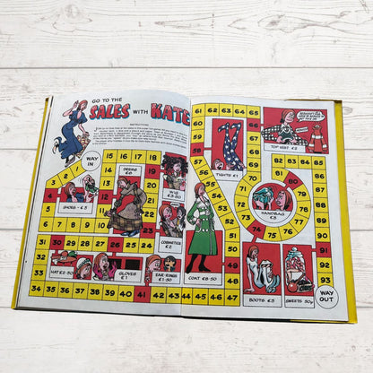 vintage Diana Annual 1974 open showing a board game on a white wood background 