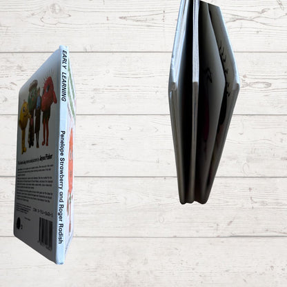 Book close up and colorful illustrations on a light wooden surface