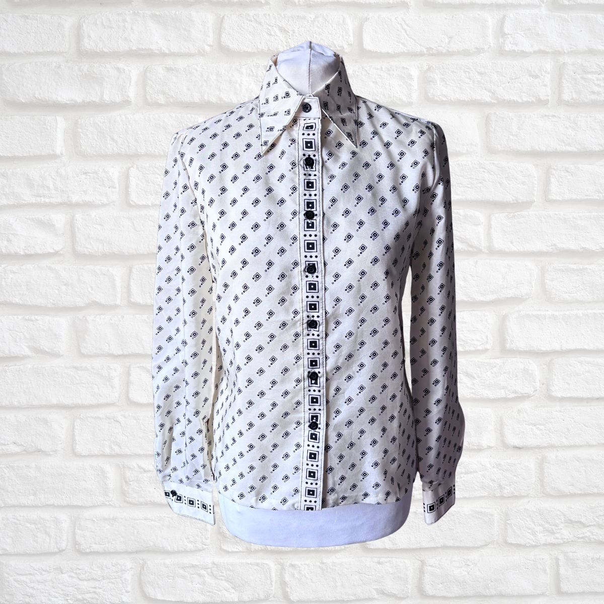 Cream and black geometric print 70s shirt on a white background 