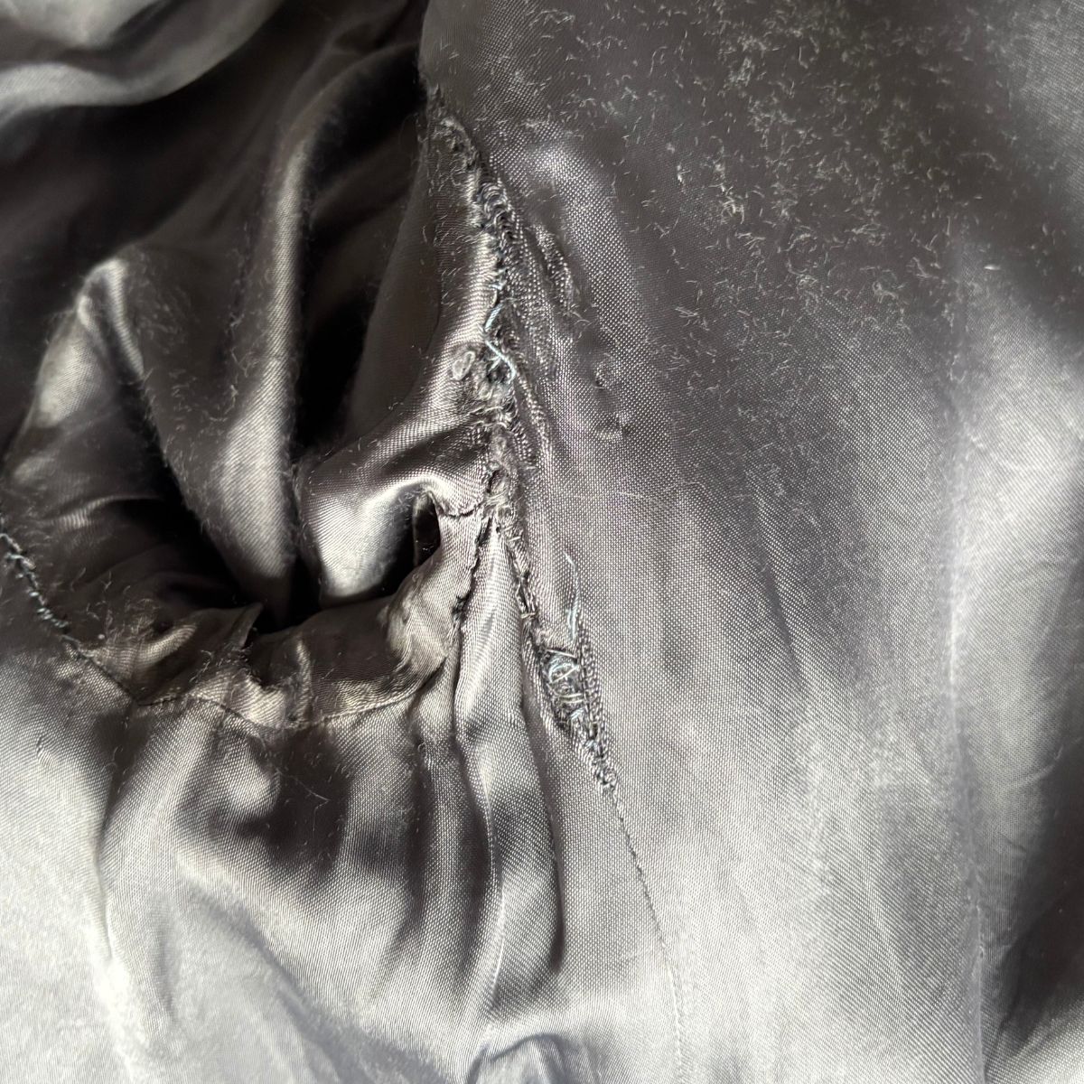 Close-up of the coat lining surface with folds and shadows.