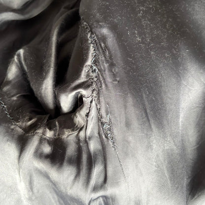 Close-up of the coat lining surface with folds and shadows.