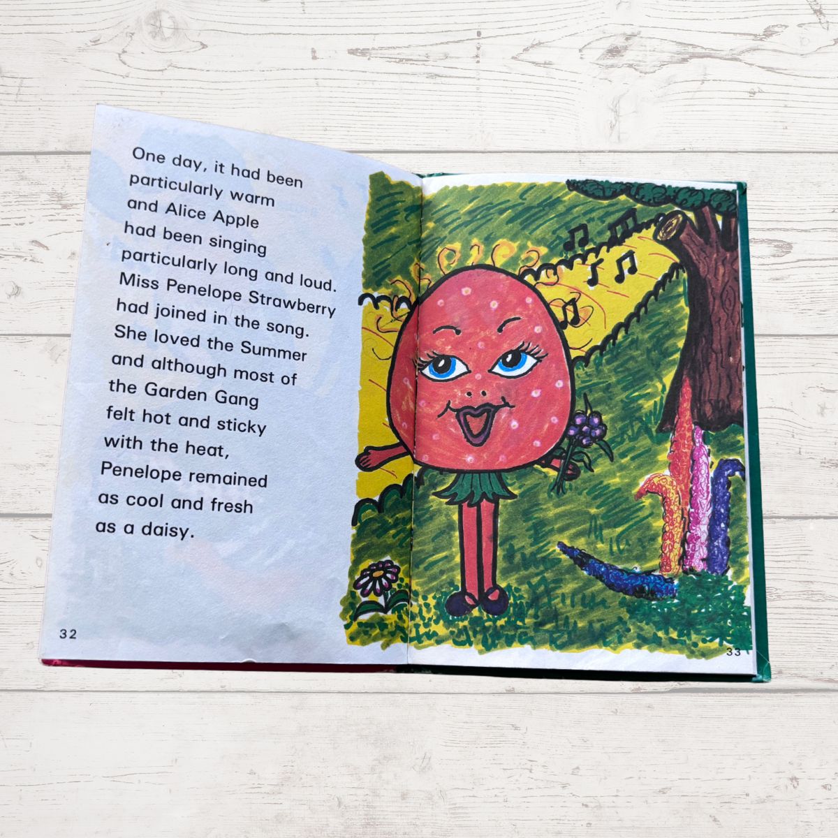Illustrated book page with a character named Miss Penelope Strawberry on a wooden surface