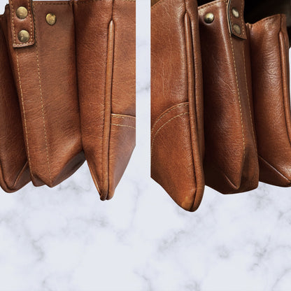 Close-up of a brown  bag with visible stitching on a marble background