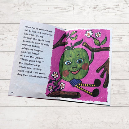 Open book with a colorful illustration of a green apple character on a pink background.
