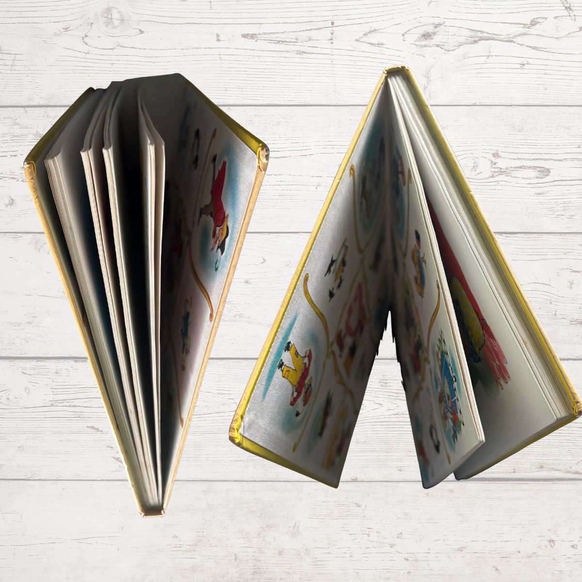 Open book with colorful illustrations on a light wooden surface
