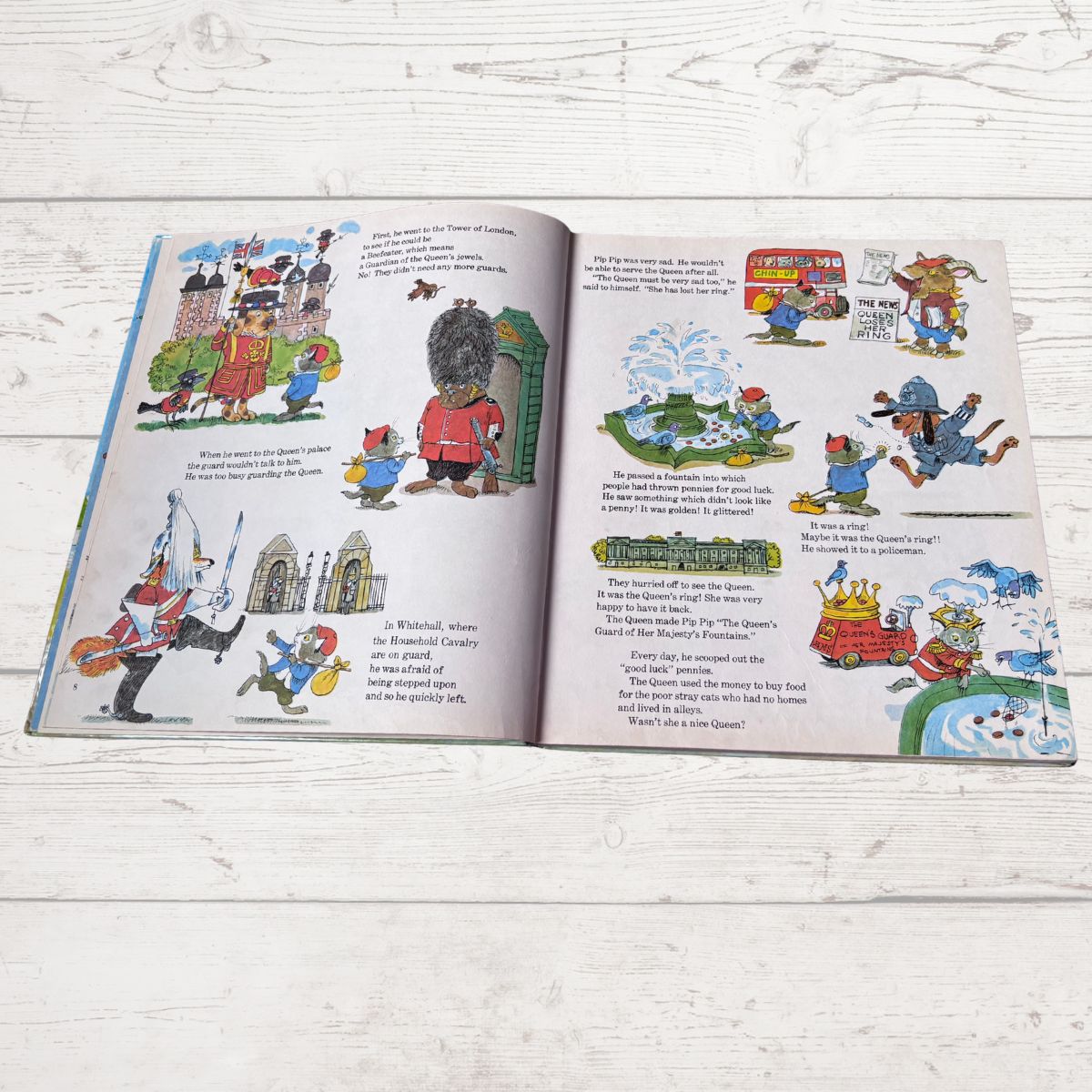 Open book with illustrated pages on a wooden surface